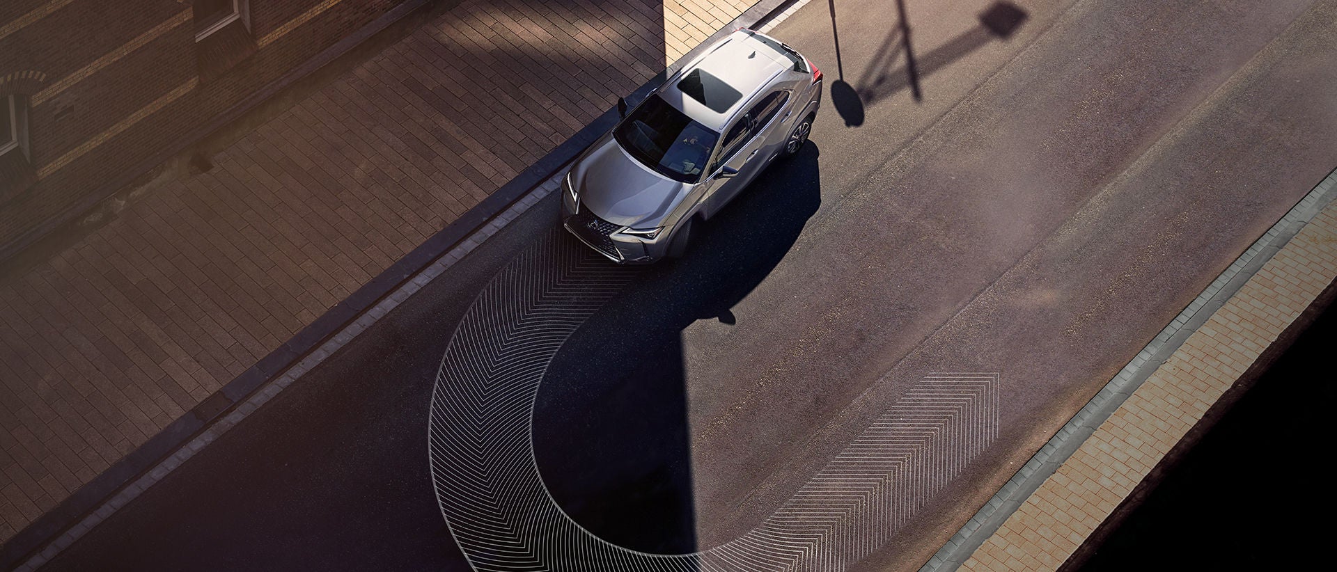 Overhead shot with a graphic demonstrating the tight turning circle of the UX Hybrid.