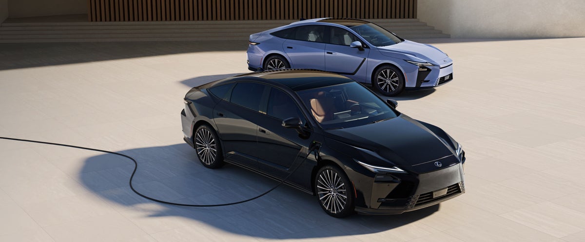 2026 Lexus ES 350e shown in Wavelength exterior color next to a charging station