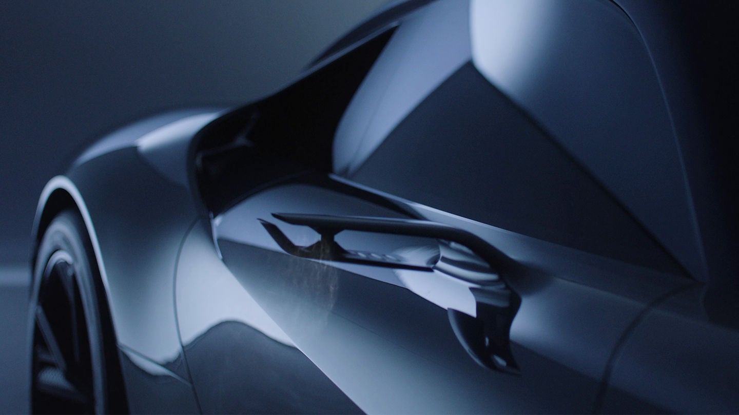 Close-up of a sleek supercar's side profile, highlighting its aerodynamic curves and side mirror in moody lighting.