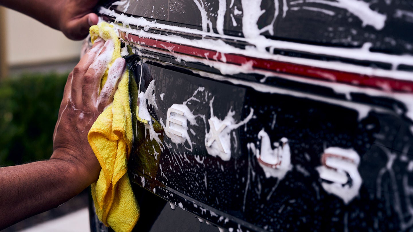 Man wiping a car.