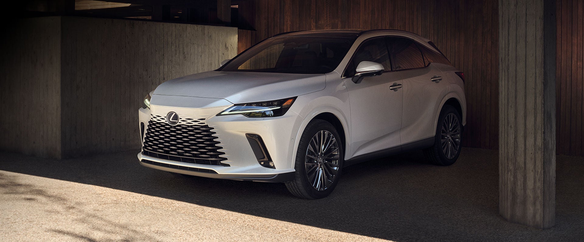 RX 350 Hybrid Luxury all-wheel drive shown in Ultra White underneath a covered parking space.