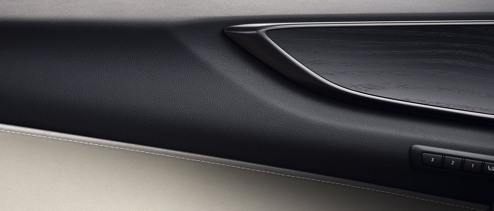 Interior of door shown with Macadamia leather and Black Open-Pore Wood trim.