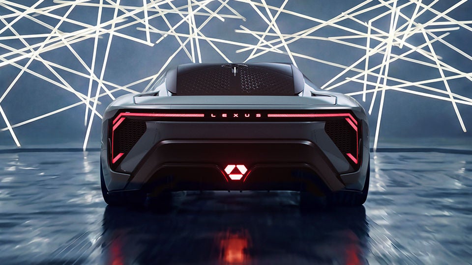 Rear view of LFA concept car with sleek red LED taillights with a background of crisscrossing lights.
