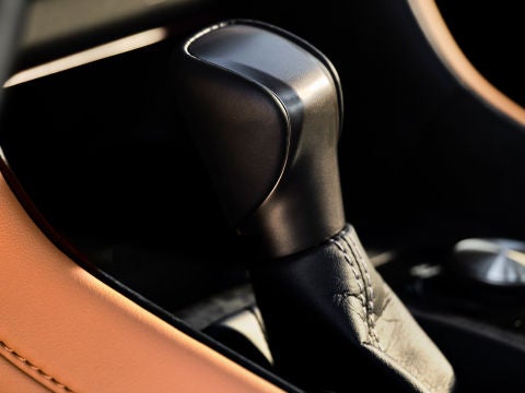 Close-up of the Drive Mode Select dial in the Lexus IS and Palomino NuLuxe trim.