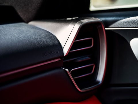 Detail of stylized front-passenger ventilation ducts.