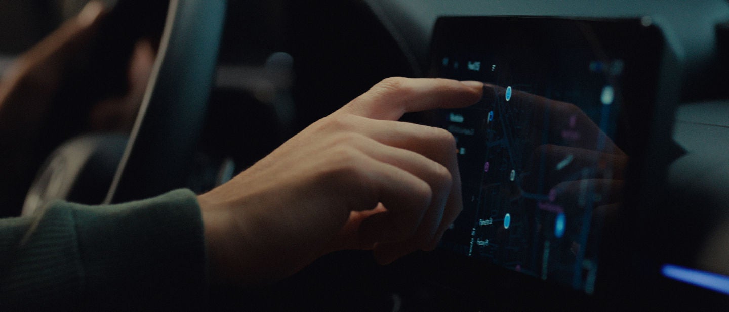 Driver interacts with the Lexus Interface touchscreen.