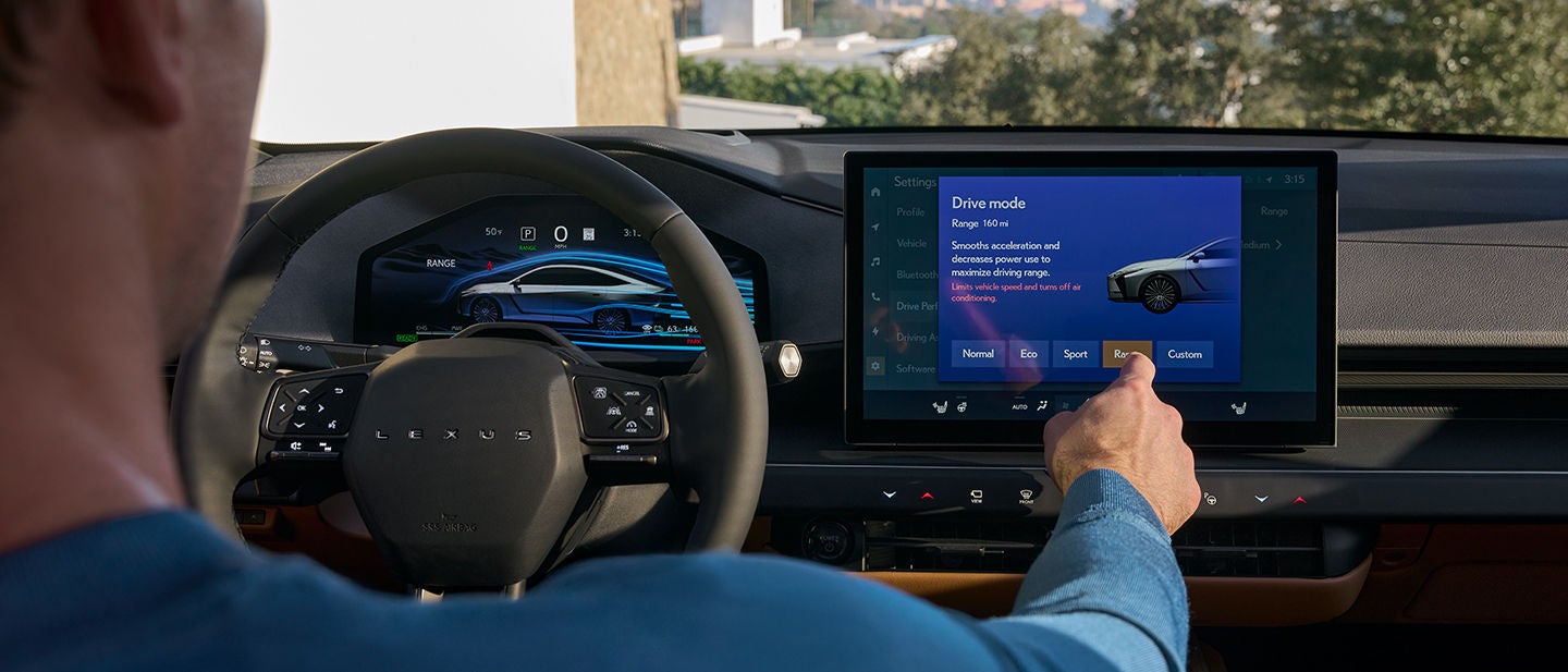 Man’s hand adjusting vehicle drive mode on Lexus Interface touchscreen.