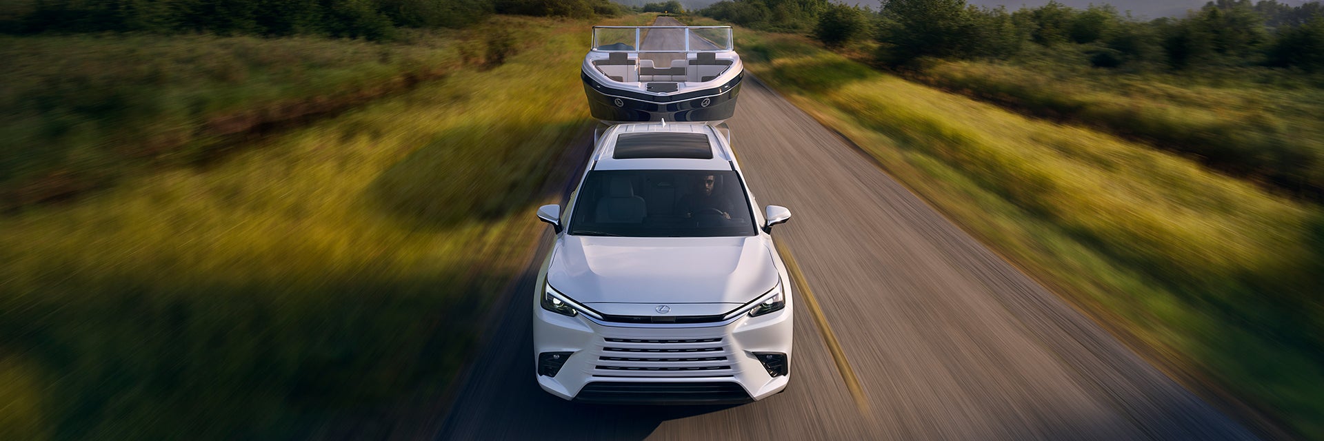 Overhead shot of a Lexus TX towing a powerboat.